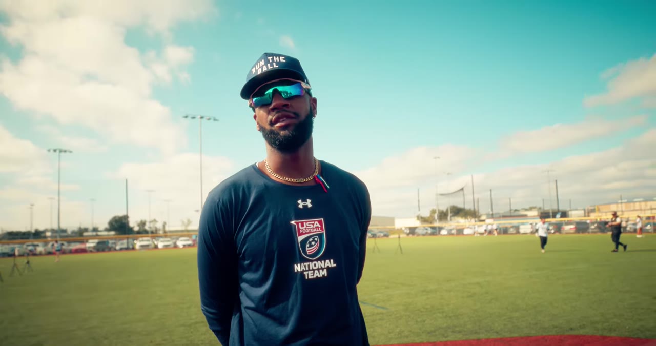 National team coach watching athletes at a combine